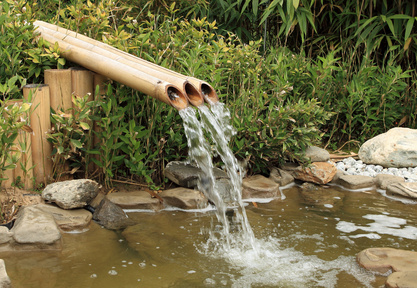 water flowing gently from bamboo pipes
